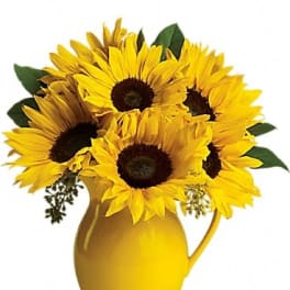 Sunflower bouquet in a yellow pitcher vase