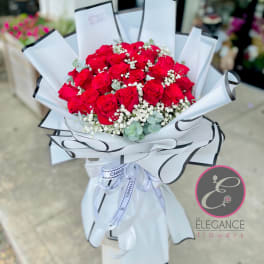 Bouquet of red roses with baby's breath in white wrap