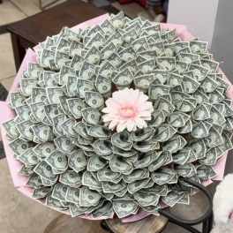 Bouquet made of folded dollar bills with a pink flower center