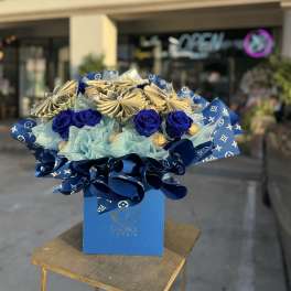 Blue roses and gold money-fold accents in a blue gift box