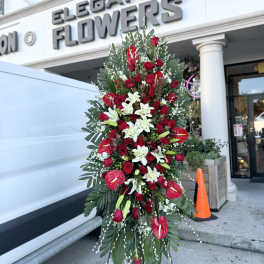 Tall standing floral spray with red roses and white lilies