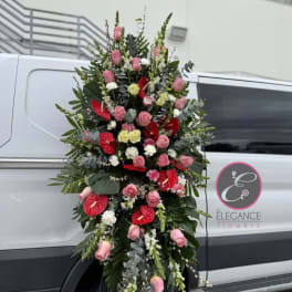 Tall standing floral spray with pink roses and red anthuriums