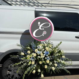 Large white and blue floral spray arranged on a vehicle