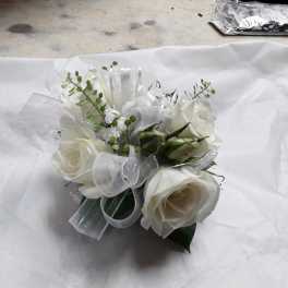 White rose bouquet with silver ribbon and small green accents