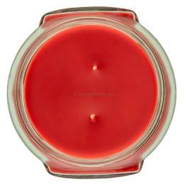 Red candle in a round glass jar