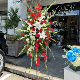 Tall standing floral spray with red roses and white lilies