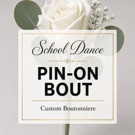 White rose boutonniere with baby's breath and round greenery