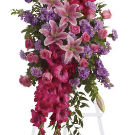 Tall pink and purple floral spray on a white easel