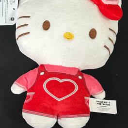 Hello Kitty plush toy in red overalls with a heart detail