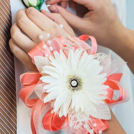 White gerbera daisy corsage with pink ribbon and pearl accents