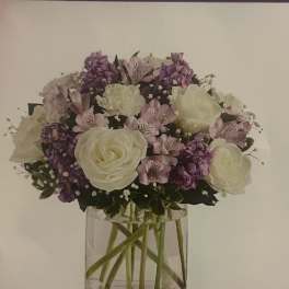 White and lavender bouquet in a clear glass vase