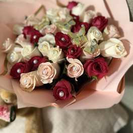 Bouquet of red and blush roses wrapped in pink paper