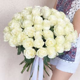 Large bouquet of white roses tied with a white ribbon