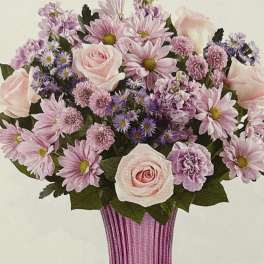 Pink and lavender bouquet in a ribbed magenta vase