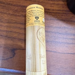 Yellow lip balm tube on a wooden surface