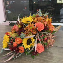 Autumn bouquet with sunflowers, orange roses, and chrysanthemums