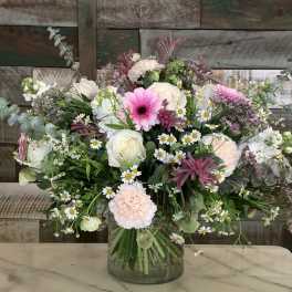 Mixed bouquet of pink and white flowers in a glass vase