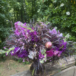Purple floral bouquet in a glass vase