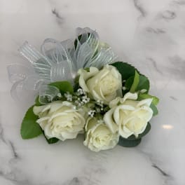 Small bouquet of white roses with a silver ribbon bow