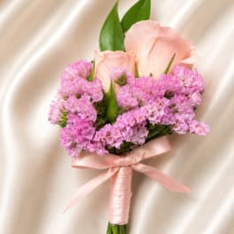 Pink rose and purple boutonniere with satin ribbon