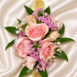 Pink rose bouquet with purple filler flowers and satin ribbon on a cream background