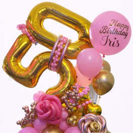Pink and gold birthday balloon arrangement with a personalized balloon
