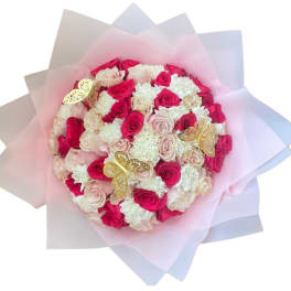 Round bouquet of pink and white roses with gold butterfly accents