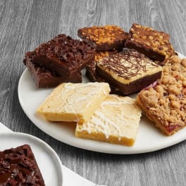 Assorted dessert bars on white plates