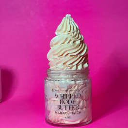 Jar of whipped body butter with a swirled cream top on a pink background