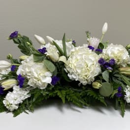 White and purple floral arrangement with hydrangeas and lilies