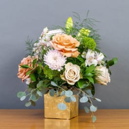 Peach and white rose bouquet in a gold box vase