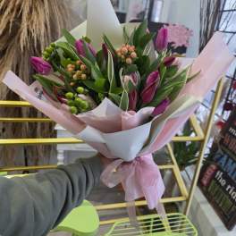 Bouquet of pink tulips wrapped in white and pink paper