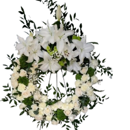 White floral funeral wreath with lilies and roses
