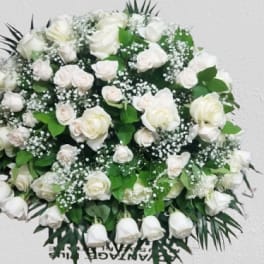 Large white rose arrangement with baby's breath and greenery