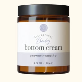 Amber jar of baby bottom cream with a black lid