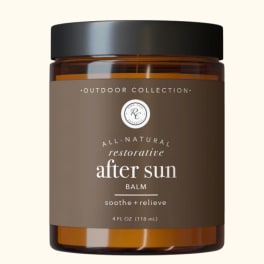 Amber jar of after-sun balm with a black lid and brown label