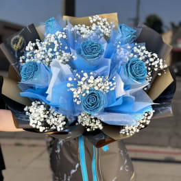 Bouquet of blue roses with white baby's breath and black wrapping