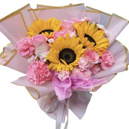 Bouquet of sunflowers and pink carnations wrapped in pink paper