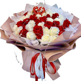 Bouquet of red and white roses with a heart topper and ribbon wrap