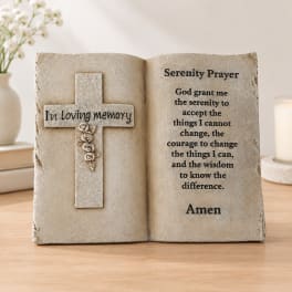 Decorative memorial plaque shaped like an open book with a cross and prayer text