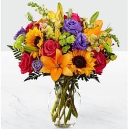 Colorful bouquet of mixed flowers in a clear glass vase