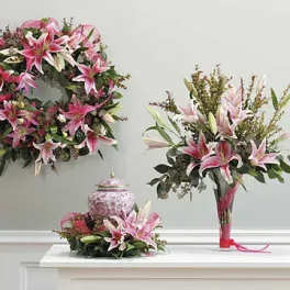 Pink lily floral wreath, bouquet, and centerpiece on a white table