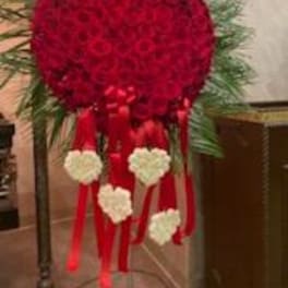 Heart-shaped red floral standing spray with white heart accents