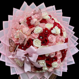 Pink and red rose bouquet with butterflies and a ribbon bow
