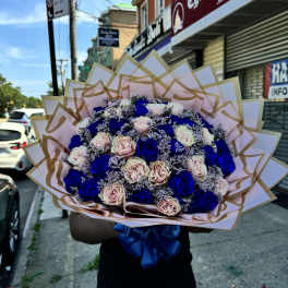 Large bouquet of blue and blush roses wrapped in pink paper