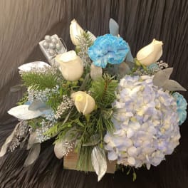 Bouquet with white roses, blue carnations, and pale hydrangea