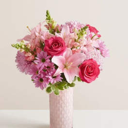Pink and lavender bouquet in a tall pink vase
