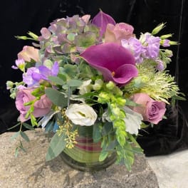 Bouquet of purple and pink flowers in a glass vase