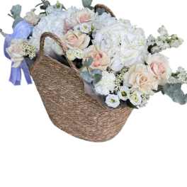 Stylish basket with flowers for a fashionable girl.