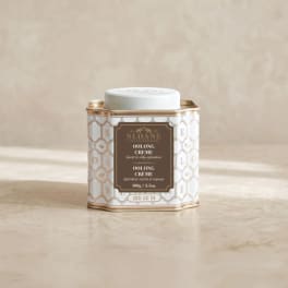 Tin of loose leaf oolong creme tea with a white lid